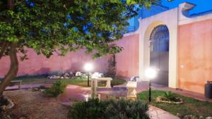 a garden with two lights in front of a building at B&B Antica Villa in Quartu SantʼElena
