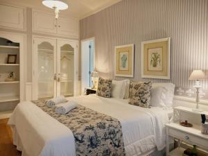 a bedroom with a bed with two pillows on it at La Belle Provence in Itaipava +99 photos