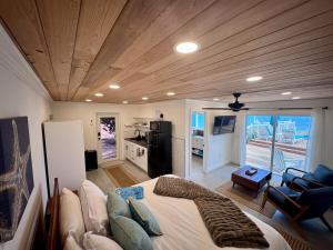 a bedroom with a large bed and a kitchen at The Calm Water Villas in Georgetown