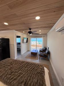a bedroom with a large bed and a ceiling fan at The Calm Water Villas in Georgetown