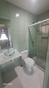 a bathroom with a toilet and a glass shower at relajate en buzios in Búzios