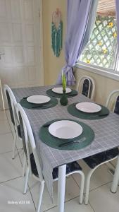 a table with chairs and plates on top of it at relajate en buzios in Búzios