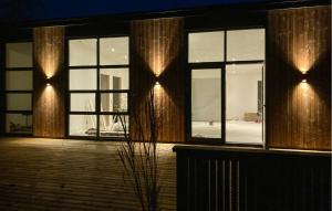 a building with large windows with lights on them at Awesome Home In Vinderup With Sauna in Vinderup