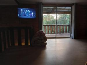 a stuffed animal sitting on a floor in front of a television at El recobeco in Artigas