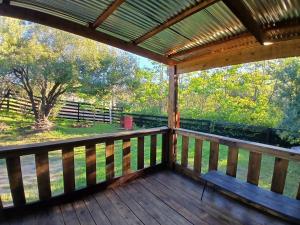 a screened in porch with a view of a pasture at El recobeco in Artigas