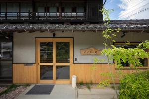 a building with a door and a sign on it at A luxurious accommodation experience surrounded by nature in Okazaki +47 photos