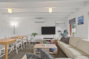 a living room with a couch and a table at 36 Lacrington St, Goolwa Beach in Goolwa South