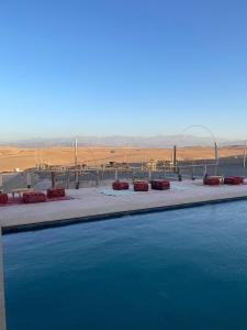a large pool of water with a view of the desert at LA HACIENDA Agafay Desert 