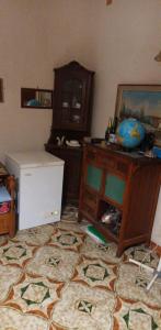 a room with a table and a desk with a globe on the floor at Margiii apart in Augusta +3 photos