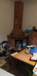 a living room with a table and a fireplace at Margiii apart in Augusta