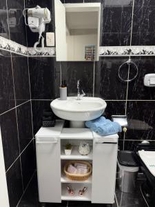 a bathroom with a sink and a white cabinet at Loft BC ESTÚDIO Centro in Balneário Camboriú +6 photos