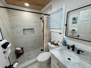 a bathroom with a sink and a toilet and a shower at The Calm Water Villas in Georgetown +18 photos