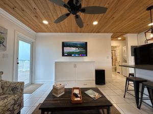 a living room with a ceiling fan and a table at The Calm Water Villas in Georgetown