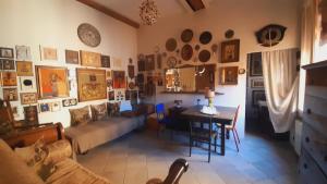 a living room with a couch and a table in a room at B&B Fuori Dai Coppi - Bologna in Bologna