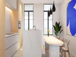 a kitchen with a white counter and a table at Spacious 3-Floor Holiday Home for 8 Guests in Bree