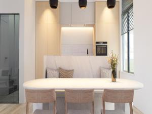 a kitchen with a white table and chairs at Spacious 3-Floor Holiday Home for 8 Guests in Bree