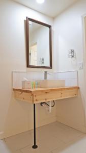 a bathroom with a sink and a mirror at Sawmill Lodges Motel in Hennessey +35 photos