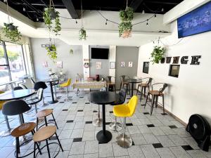 a restaurant with tables and chairs in a room at Hotel Paris in Tijuana