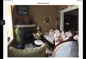 a living room with two couches and a fireplace at Barry and Elaine in Abbotsford