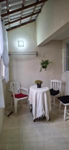 a room with a table and two chairs and a table and chairs at Shanti House Geribá in Búzios