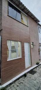 a house with two windows on the side of it at Shanti House Geribá in Búzios