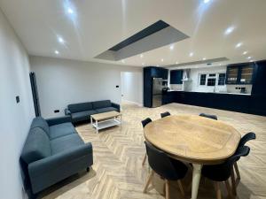 a living room with a couch and a table at Richard guest house in Roydon