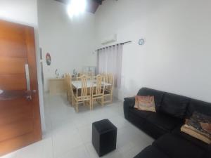a living room with a couch and a table at Aconchegante in Peruíbe