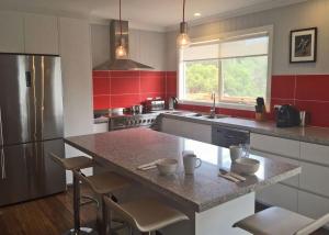a kitchen with a large island in the middle at Eastgarth in Venus Bay