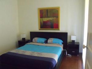 Giường trong phòng chung tại Emada Venus Bay