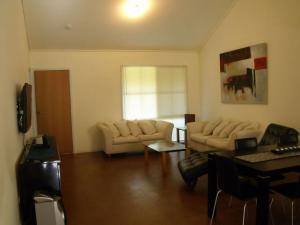 a living room with a couch and a table at Emada Venus Bay in Venus Bay