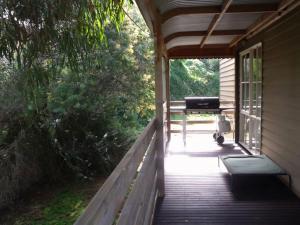 a porch of a house with a grill on it at Emada Venus Bay in Venus Bay