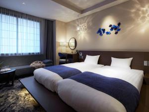 Ένα ή περισσότερα κρεβάτια σε δωμάτιο στο Minn Kanazawa +46 φωτογραφίες