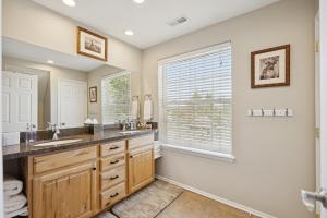 a bathroom with two sinks and a window at Creekside cutie 3br 2.5ba near skiing sleeps 8 in Kamas +48 photos