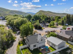 an aerial view of a home in a small town with mountains at Creekside cutie 3br 2.5ba near skiing sleeps 8 in Kamas
