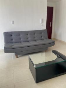 a couch in a living room with a glass table at Apartamento en Manizales in Manizales