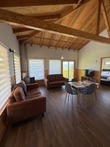 a living room with a couch and a table at Cabañas dunn in Puerto Cisnes +7 photos