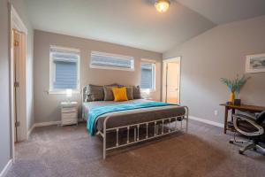 a bedroom with a bed and a desk and windows at Boutique CDA Stay in Atlas
