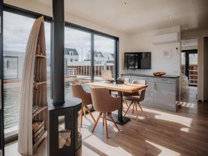 a kitchen and dining room with a wood stove at Spacious HouseBoat in Peenemünde in Peenemünde