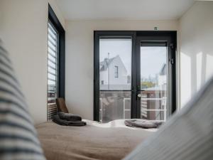 a bedroom with a bed and a large window at Spacious HouseBoat in Peenemünde in Peenemünde