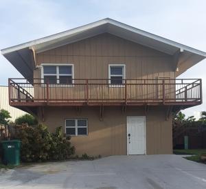 a house with a deck on the side of it at Waterfront Cottage in Marco Island