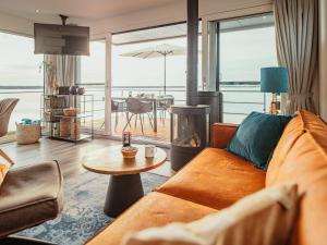 a living room with a couch and a fire place at Hausboot am Gräbendorfer in Gräbendorf