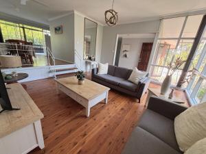 a living room with a couch and a coffee table at Bright & Spacious Getaway - East Gosford in Point Frederick