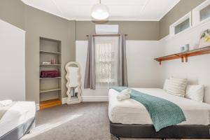 a bedroom with two beds and a window at Bendigo Signature Accommodation on Vine in Bendigo