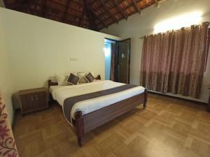 奇克马格尔Arabica Aura Homestay的房间里有一张大床的卧室