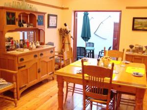 a kitchen with a table and a dining room at The Farmhouse B&B in Port Elizabeth