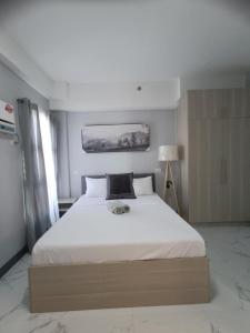 Ένα ή περισσότερα κρεβάτια σε δωμάτιο στο Royal Ocean Crest Cebu Stay Rental