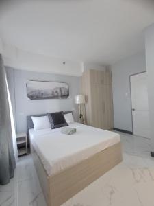 Ένα ή περισσότερα κρεβάτια σε δωμάτιο στο Royal Ocean Crest Cebu Stay Rental
