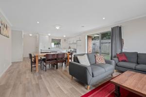 a living room with a couch and a table at Time to Relax in Portarlington