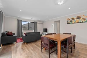 a living room with a table and a couch at Time to Relax in Portarlington