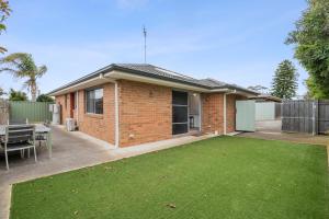 a brick house with a lawn in front of it at Time to Relax in Portarlington